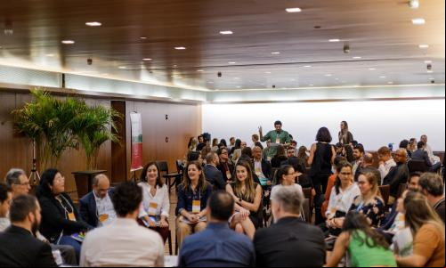 reunião com muitas pessoas sentadas conversando sobre projetos